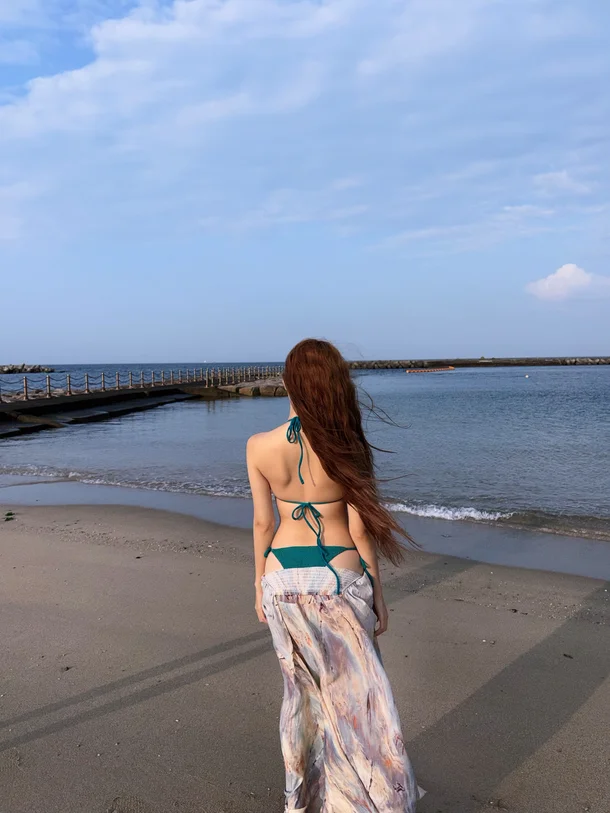 Billlie Tsuki wearing an emerald bikini and long skirt on Awaji Island beach