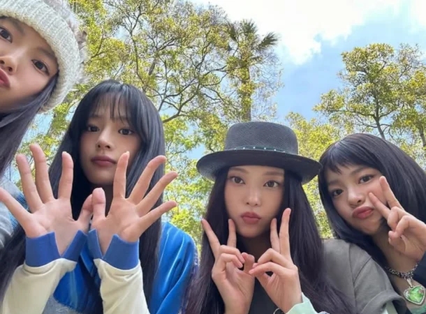 NewJeans members Minji Hanni Haerin Hyein posing together for 4th anniversary updates
