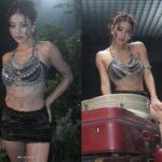TWICE Jihyo posing in a sparkling silver chain halterneck top and fur mini skirt backstage