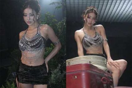 TWICE Jihyo posing in a sparkling silver chain halterneck top and fur mini skirt backstage