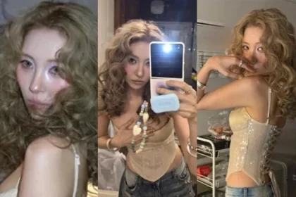 Sunmi wearing a champagne gold sequined corset top with a bright golden brown hippie perm hair on a music video set
