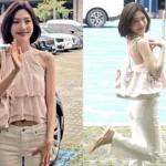 Red Velvet Joy wearing a white halter neck crop top and white pants showcasing her slim waist line