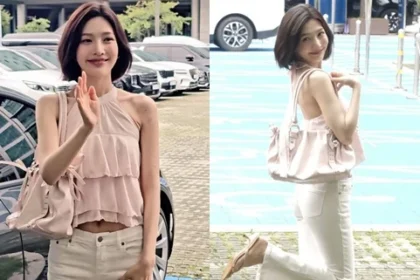 Red Velvet Joy wearing a white halter neck crop top and white pants showcasing her slim waist line