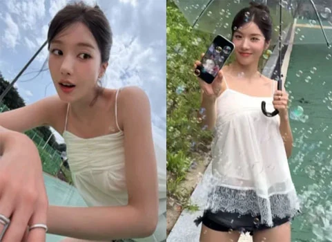 Kwon Eunbi smiling under a clear umbrella in a white slip top and black shorts