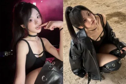 QWER Hina with a high ponytail and black choker smiling