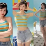 Red Velvet Joy wearing a white sleeveless crop top and denim shorts