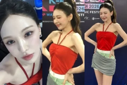 Red Velvet member Wendy posing backstage at K-Pulse Hanoi in a red halterneck top and gray skirt.