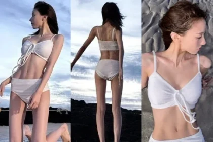 Sheon from the K-pop group Billlie posing for a photo in a white swimsuit on a sunny Jeju beach, with a clear blue sea background.