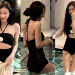 Y Chaeryeong wearing a cutout black swimsuit with white flower details for a night swim