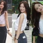 IVE An Yujin posing over-the-shoulder in a white lace crop top and blue jeans