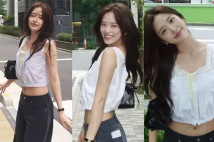 IVE An Yujin posing over-the-shoulder in a white lace crop top and blue jeans