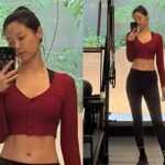 Former AOA member Seolhyun showing off her six-line abs in a bra top and leggings at the gym