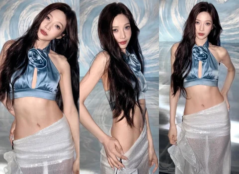 Red Velvet Joy posing in a blue halter crop top and white skirt during a photoshoot