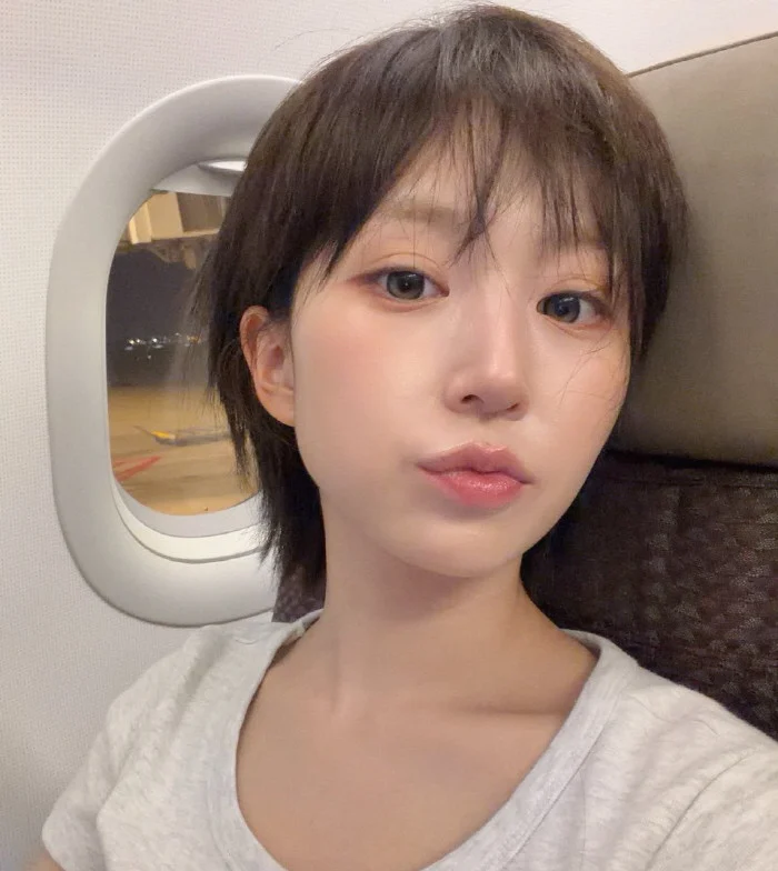 NMIXX’s Haewon Debuts Voluminous Wavy Look, Putting an End to the "Short Hair" Buzz Haewons viral short hair selfie