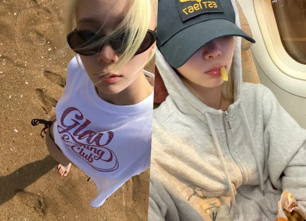 aespa Winter taking a selfie on the beach wearing sunglasses and a white t-shirt