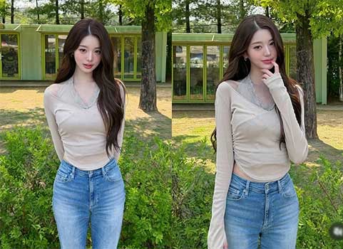 Jang Wonyoung wearing a beige halter-neck top and denim jeans at an amusement park