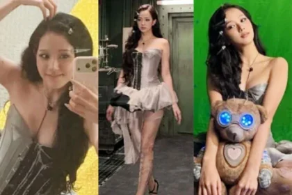 BLACKPINK member Jisoo posing at an amusement park showing off her doll-like visuals